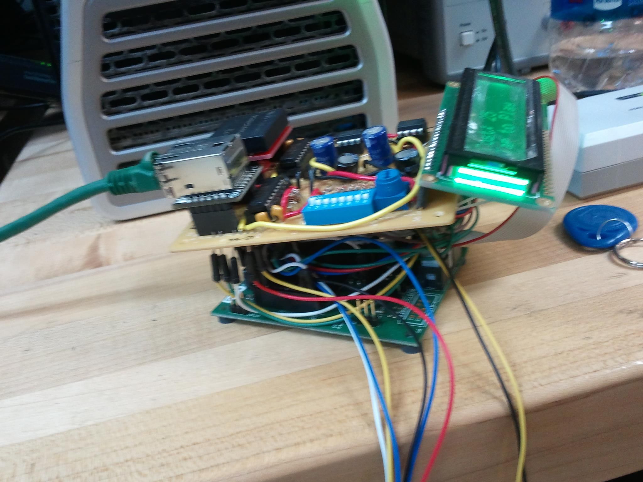 The SmartPlay arcade game device which would be mounted on arcade game cabinets to replace coin slots and ticket dispenser. It has an back lit color LCD to display message, price and user instructions. It also has the RFID reader to identify users. Via the network port the device connects to the server to process user requests or receive commands from the admin panel. This was a WIP photo.
