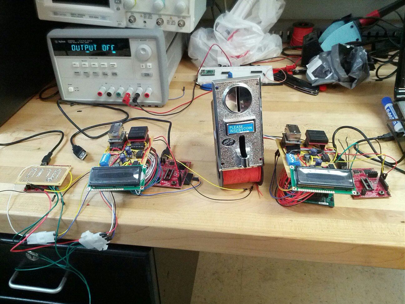 Full view of the SmartPlay system hardware devices. From left to right: arcade machine emulator, SmartPlay arcade game device, SmartPlay recharge station device.